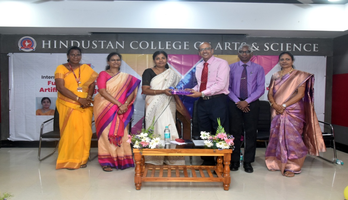Dr. V.J. Philip, Deputy Director of Academics, presenting a memento to Dr. L. Lakshmi.